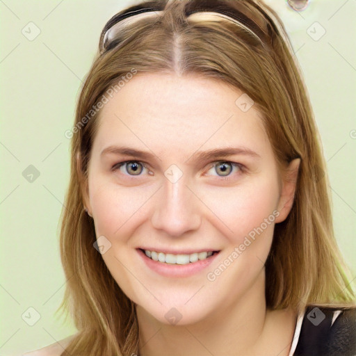 Joyful white young-adult female with long  brown hair and blue eyes