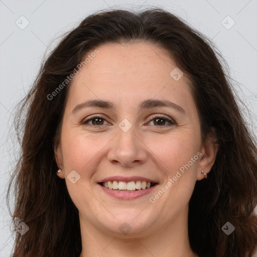 Joyful white adult female with long  brown hair and brown eyes