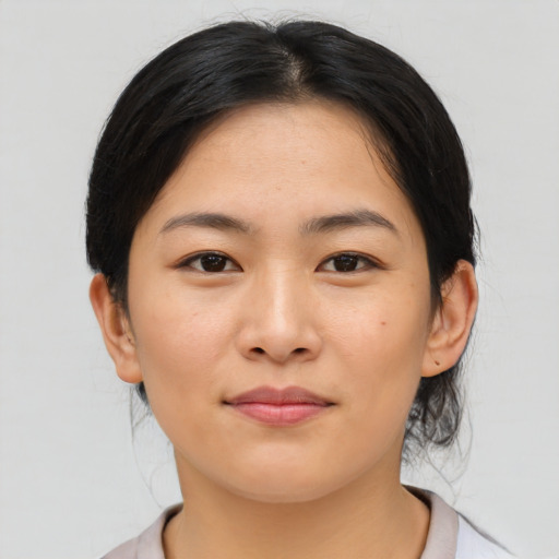 Joyful asian young-adult female with medium  brown hair and brown eyes
