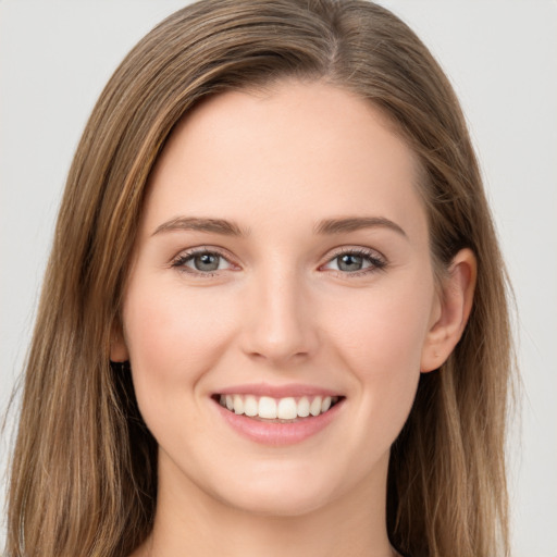 Joyful white young-adult female with long  brown hair and green eyes