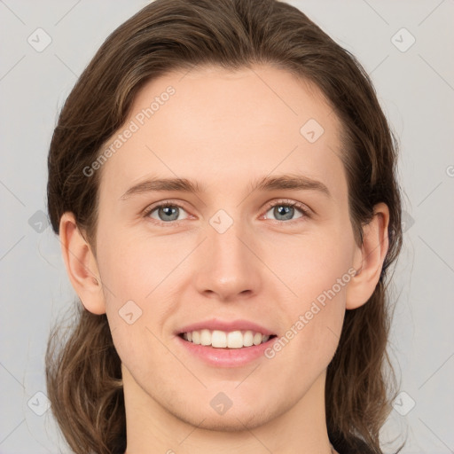 Joyful white young-adult female with medium  brown hair and grey eyes