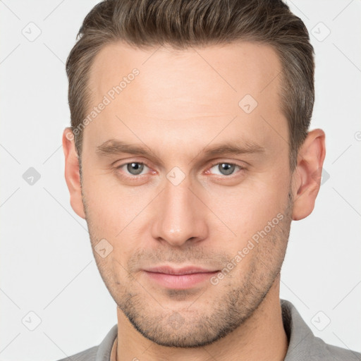 Joyful white young-adult male with short  brown hair and brown eyes