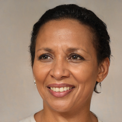 Joyful latino adult female with medium  brown hair and brown eyes
