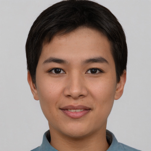 Joyful asian young-adult male with short  brown hair and brown eyes