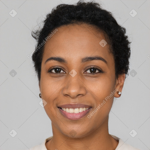 Joyful black young-adult female with short  black hair and brown eyes