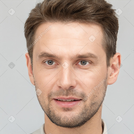 Joyful white young-adult male with short  brown hair and brown eyes