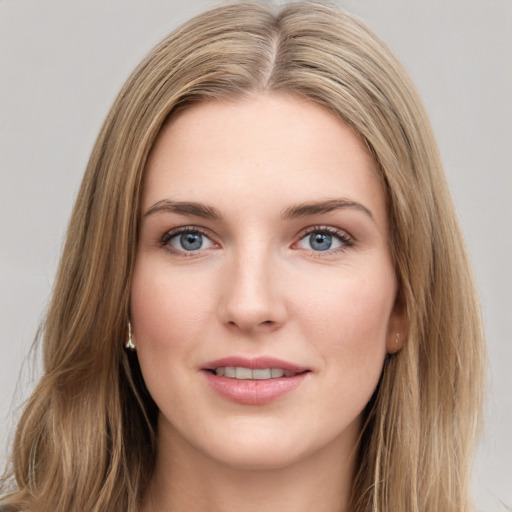 Joyful white young-adult female with long  brown hair and blue eyes