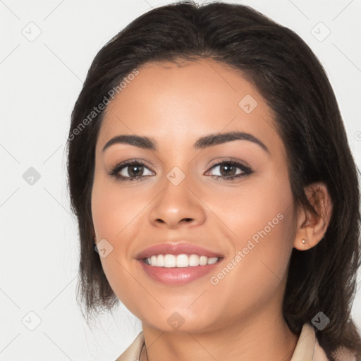 Joyful latino young-adult female with long  black hair and brown eyes