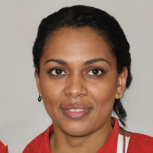 Joyful black young-adult female with short  black hair and brown eyes