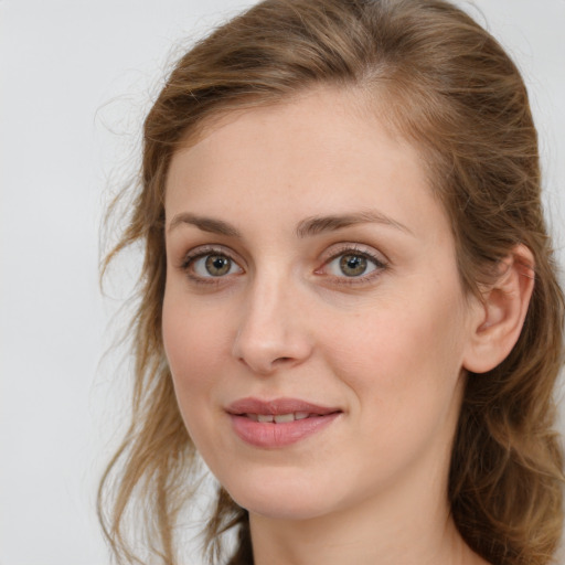 Joyful white young-adult female with medium  brown hair and green eyes