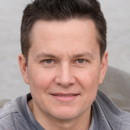 Joyful white adult male with short  brown hair and grey eyes