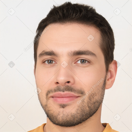 Joyful white young-adult male with short  brown hair and brown eyes