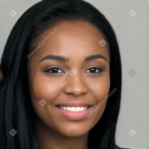 Joyful black young-adult female with long  black hair and brown eyes