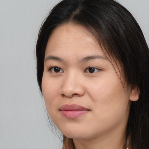 Joyful asian young-adult female with long  brown hair and brown eyes