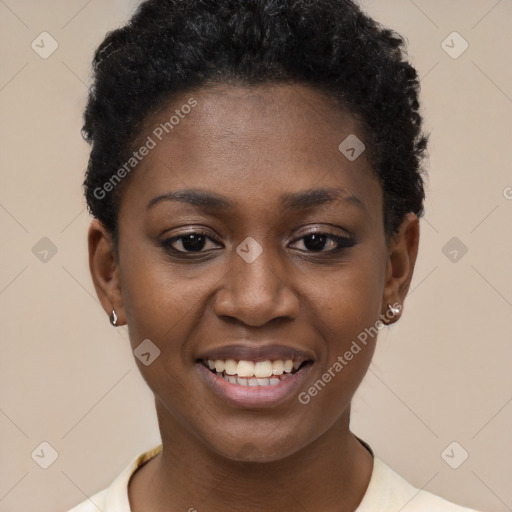 Joyful black young-adult female with short  black hair and brown eyes