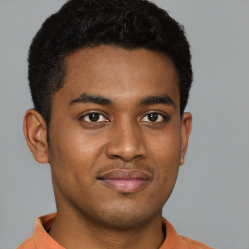 Joyful black young-adult male with short  brown hair and brown eyes