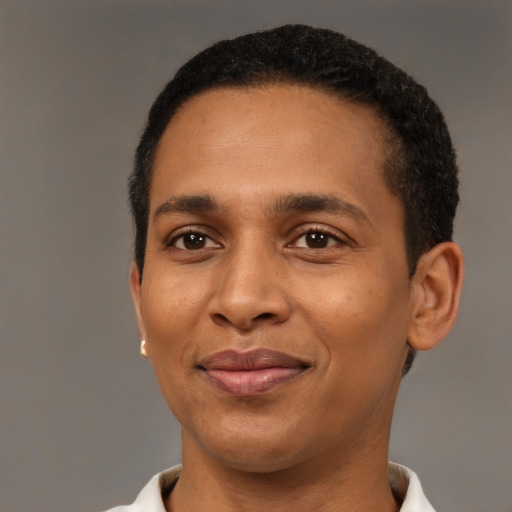 Joyful black young-adult male with short  black hair and brown eyes