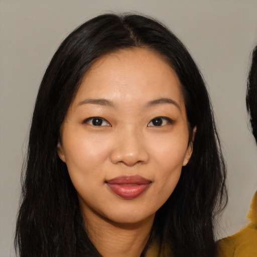 Joyful asian young-adult female with long  brown hair and brown eyes