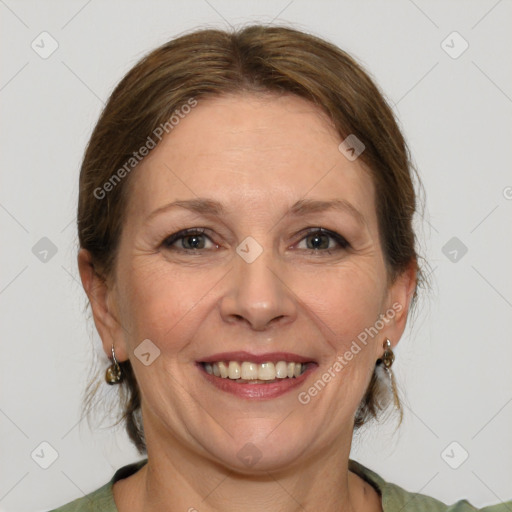 Joyful white adult female with medium  brown hair and green eyes