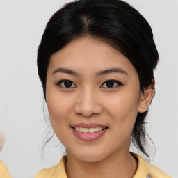 Joyful asian young-adult female with medium  black hair and brown eyes