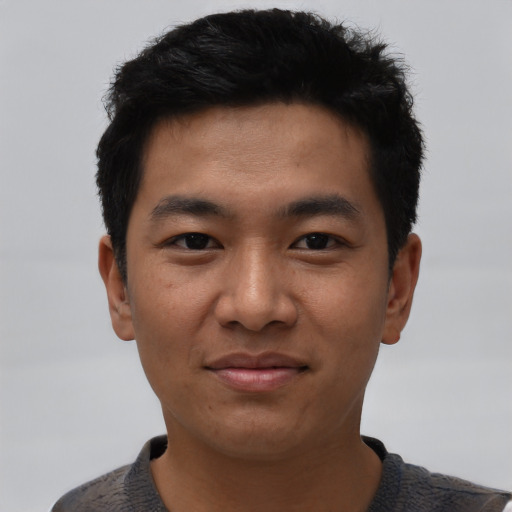 Joyful asian young-adult male with short  black hair and brown eyes