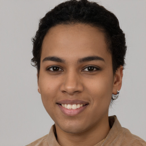 Joyful latino young-adult female with short  brown hair and brown eyes