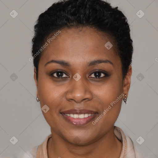 Joyful black young-adult female with short  black hair and brown eyes