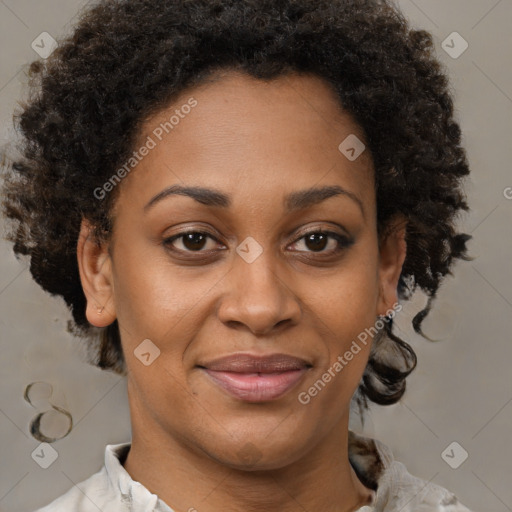 Joyful black adult female with short  brown hair and brown eyes