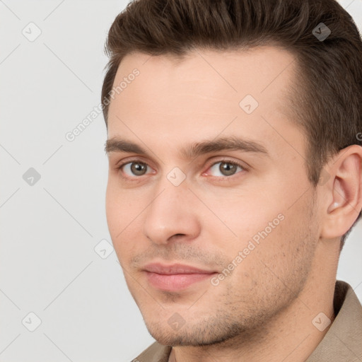 Joyful white young-adult male with short  brown hair and brown eyes