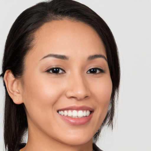 Joyful white young-adult female with long  brown hair and brown eyes