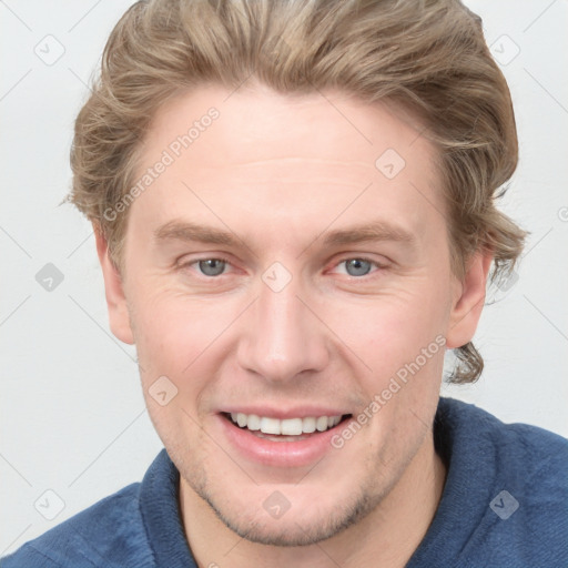 Joyful white young-adult male with short  brown hair and blue eyes