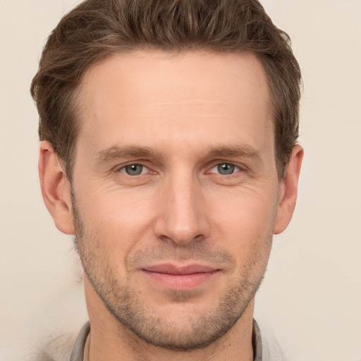 Joyful white adult male with short  brown hair and brown eyes