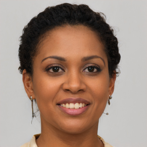 Joyful latino young-adult female with short  brown hair and brown eyes