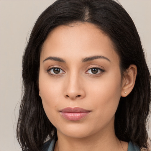 Joyful latino young-adult female with long  brown hair and brown eyes