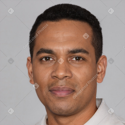 Joyful black young-adult male with short  black hair and brown eyes