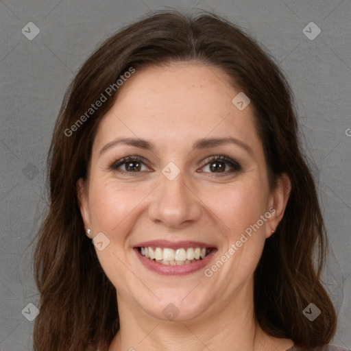 Joyful white adult female with long  brown hair and brown eyes