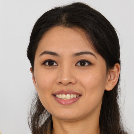 Joyful asian young-adult female with long  brown hair and brown eyes