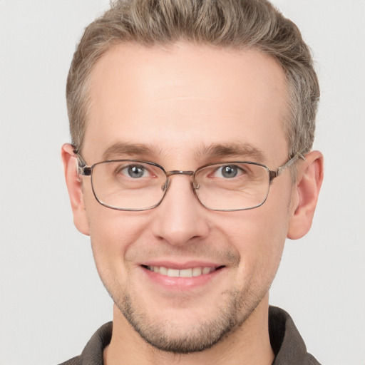 Joyful white adult male with short  brown hair and grey eyes