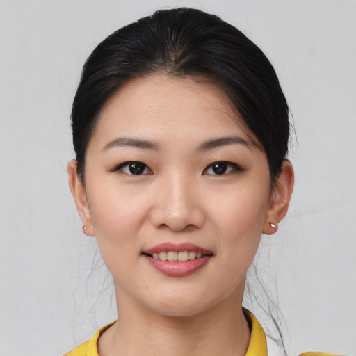 Joyful asian young-adult female with short  black hair and brown eyes