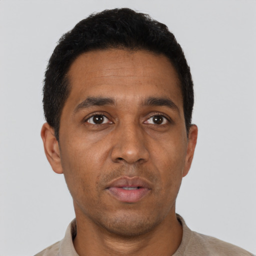 Neutral black adult male with short  black hair and brown eyes
