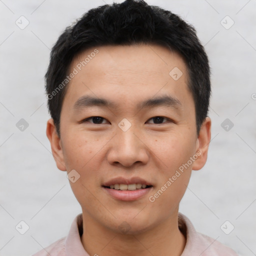 Joyful asian young-adult male with short  black hair and brown eyes