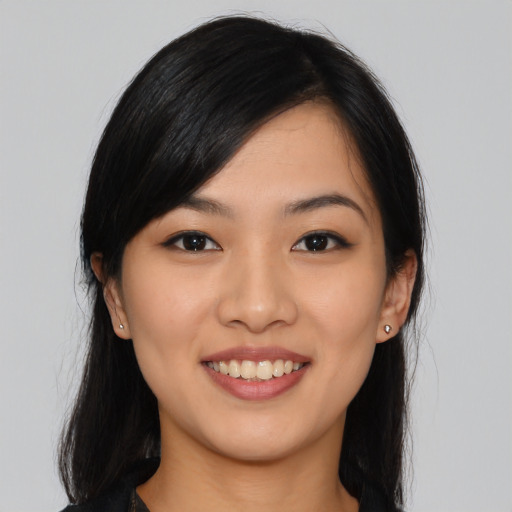 Joyful asian young-adult female with long  black hair and brown eyes
