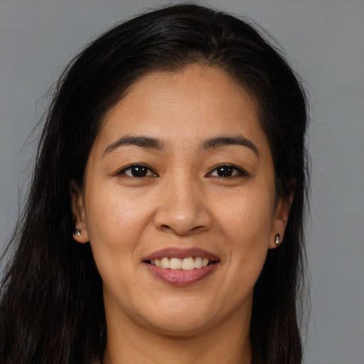 Joyful asian young-adult female with long  brown hair and brown eyes