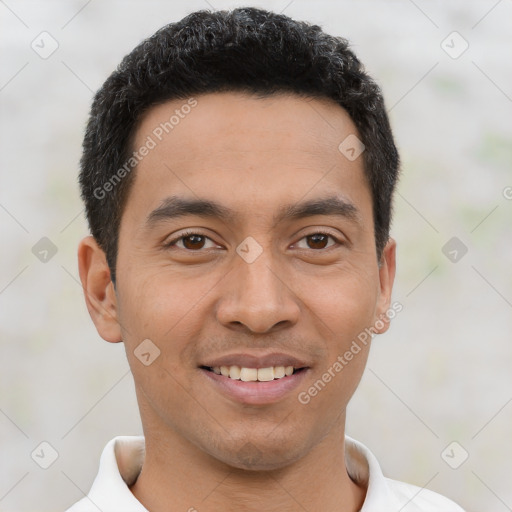 Joyful latino young-adult male with short  brown hair and brown eyes