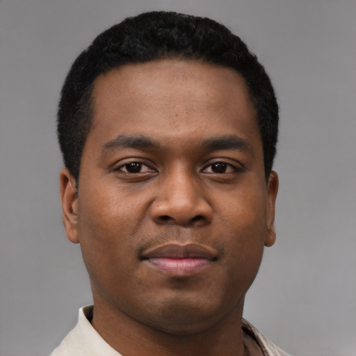 Joyful black young-adult male with short  black hair and brown eyes