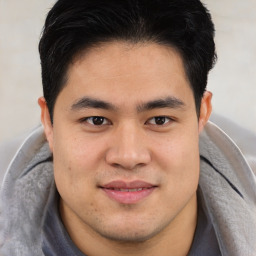 Joyful latino young-adult male with short  brown hair and brown eyes