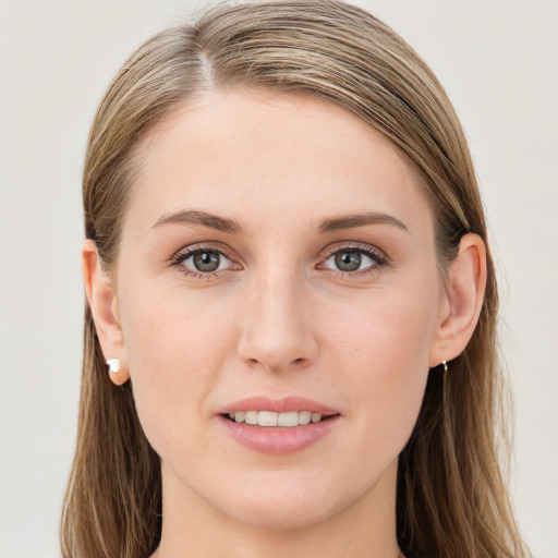 Joyful white young-adult female with long  brown hair and blue eyes