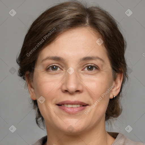 Joyful white adult female with medium  brown hair and grey eyes