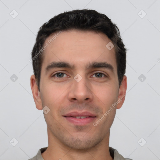 Joyful white young-adult male with short  black hair and brown eyes