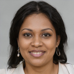 Joyful black young-adult female with medium  brown hair and brown eyes